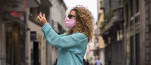 Woman do video phone call wearing medical protection mask