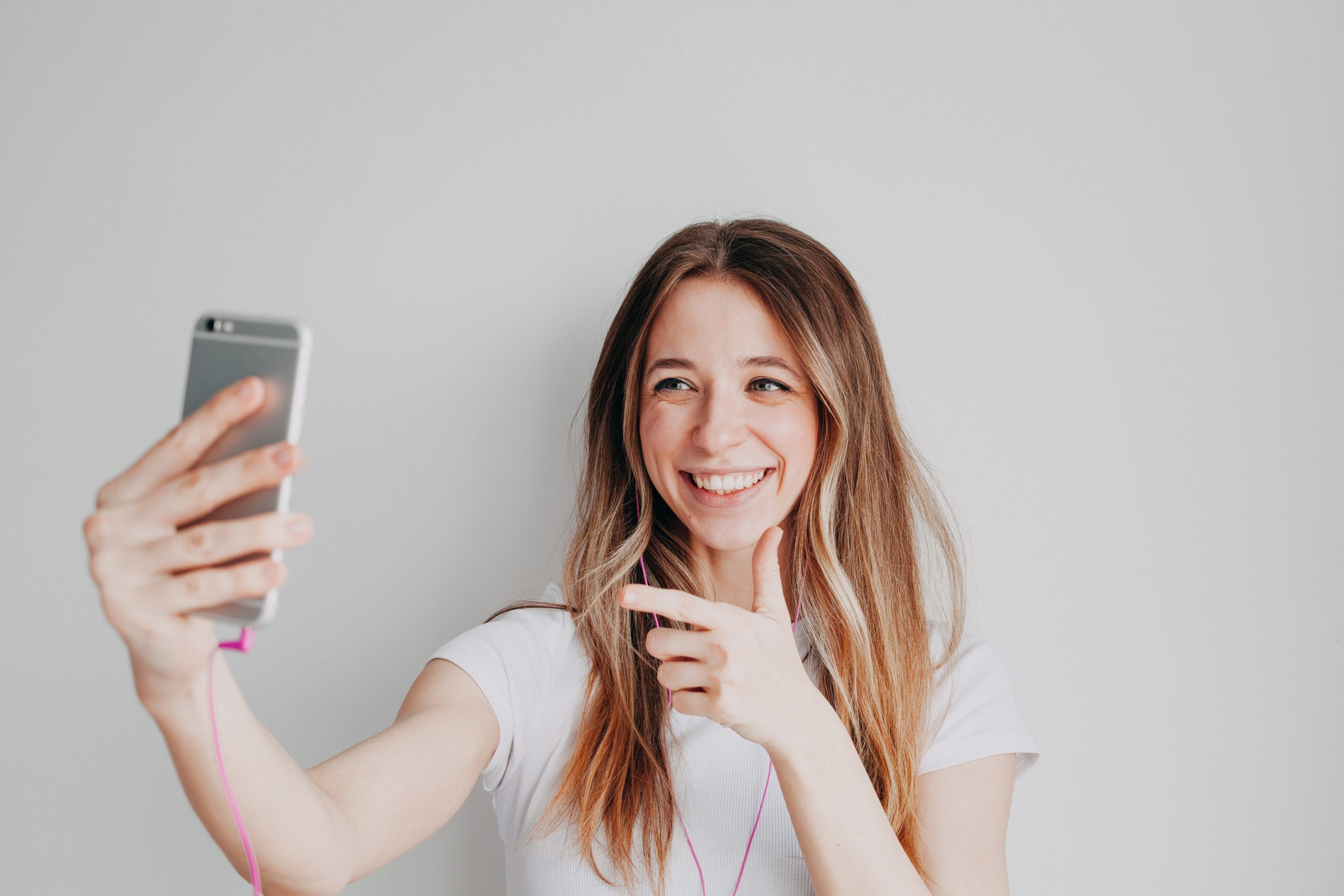 young-smiling-girl-are-talking-on-video-by-phone